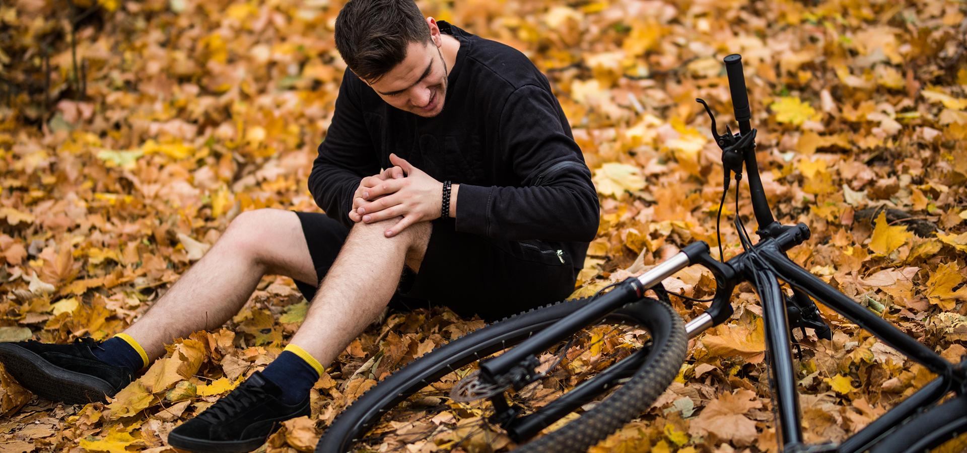 https://borenlaw.com/wp-content/uploads/2025/02/active-young-man-holding-by-his-hurt-broken-leg-while-lying-autumn-forest-path-by-his-bicycle-1.png
