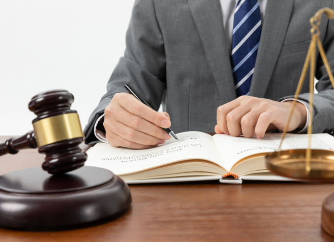closeup-shot-person-writing-book-with-gavel-table (3)