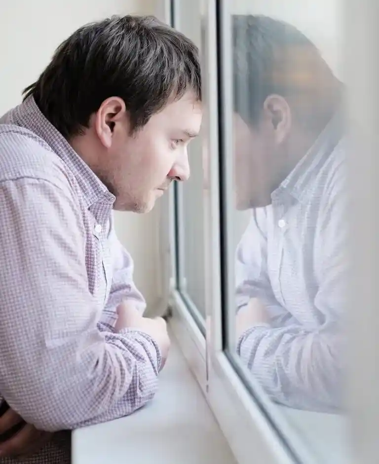 Middle age man looking at the window